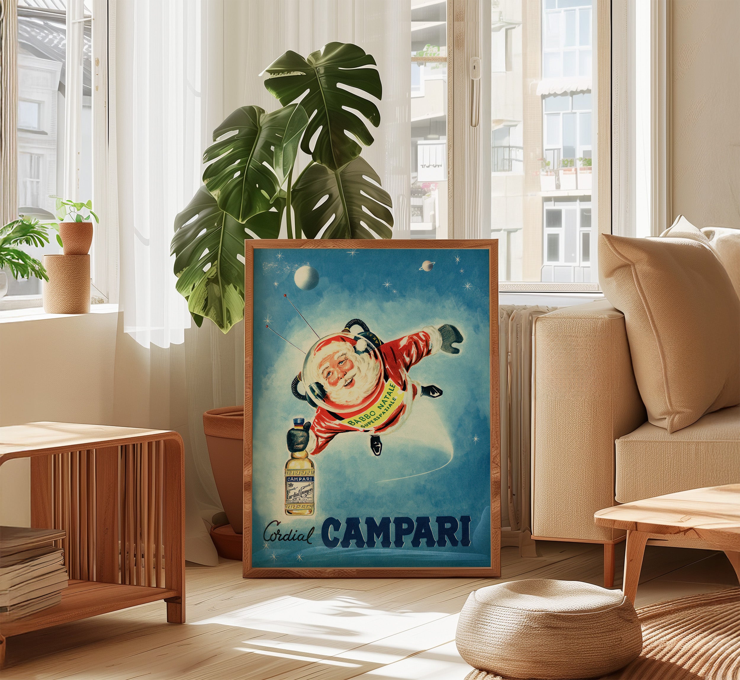 Framed Cordial Campari Space Santa vintage poster displayed in a bright contemporary living room with warm wood furniture and large green plants.