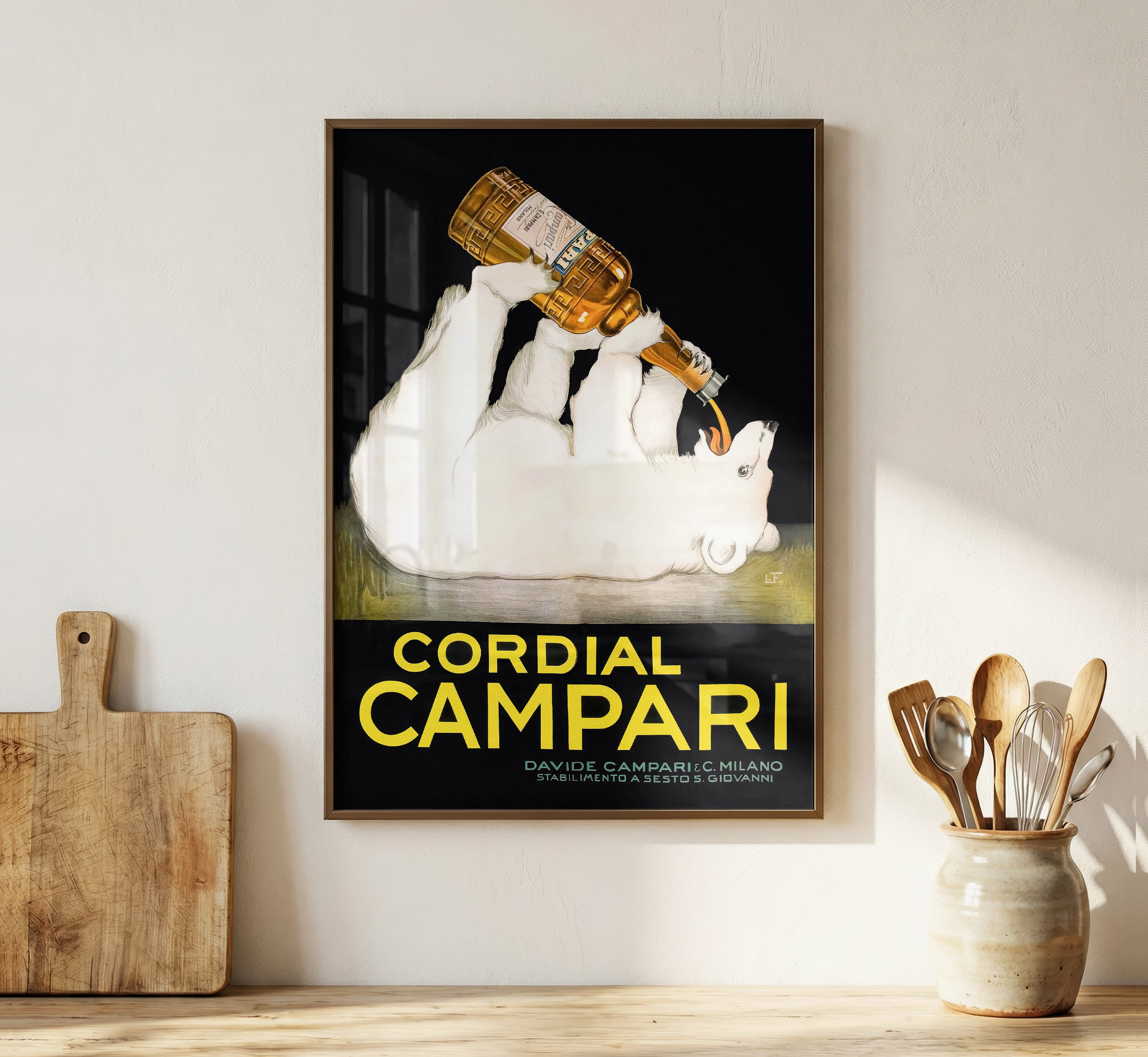 Cordial Campari vintage advertising poster displayed as framed wall art in a warm minimalist kitchen interior.