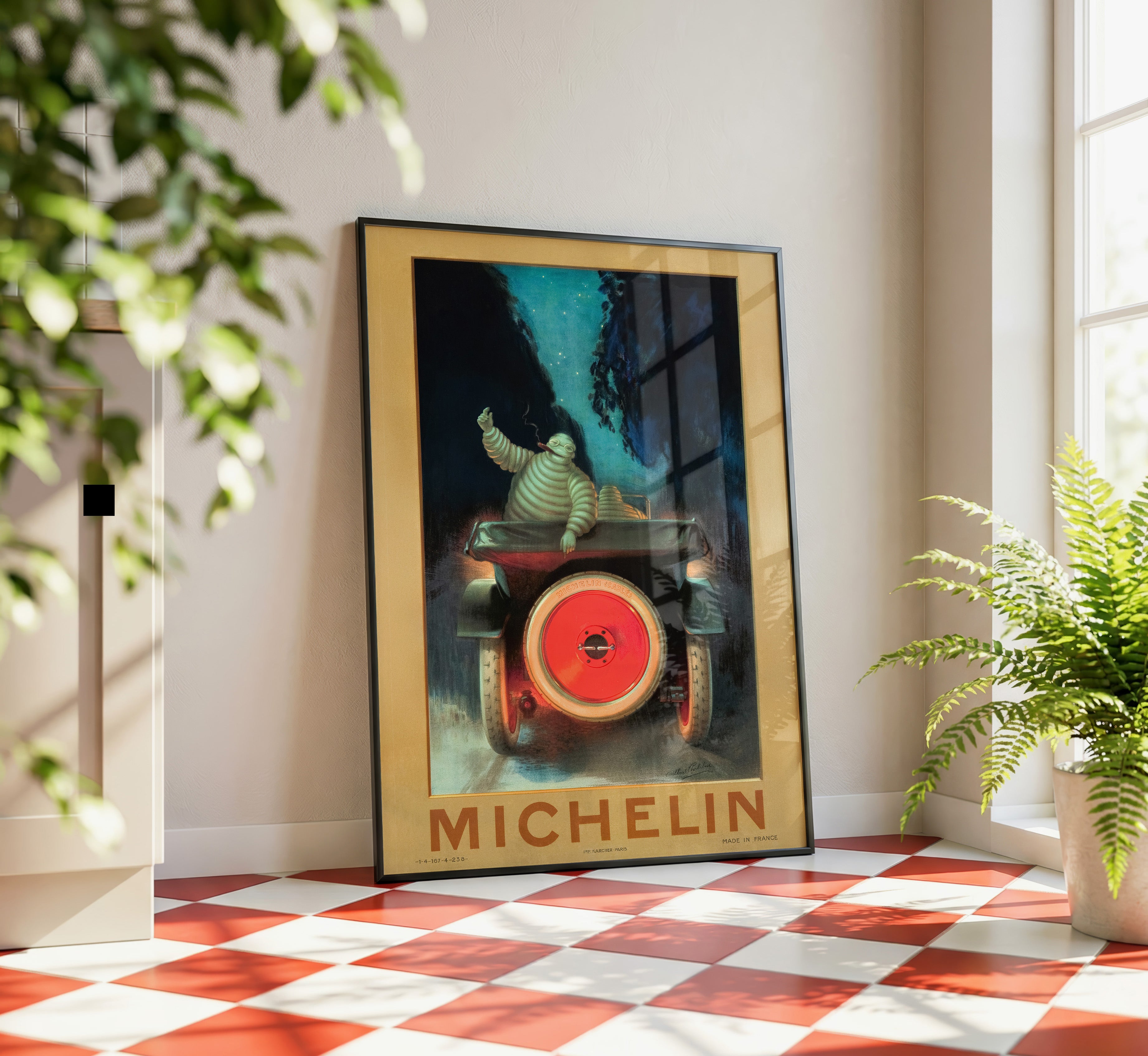 Framed vintage Michelin Bibendum automotive poster displayed in a bright interior with red and white checkerboard flooring.
