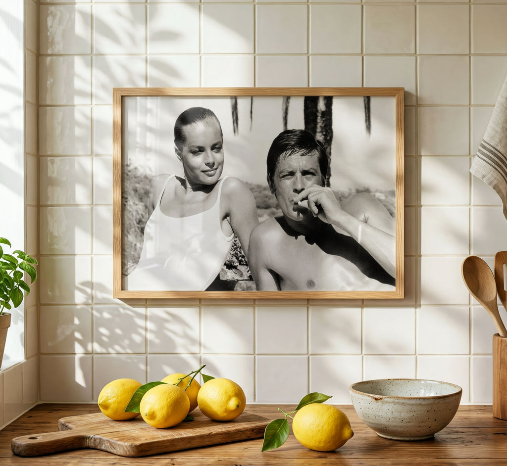 Framed black and white photograph of Romy Schneider and Alain Delon styled in a warm modern interior