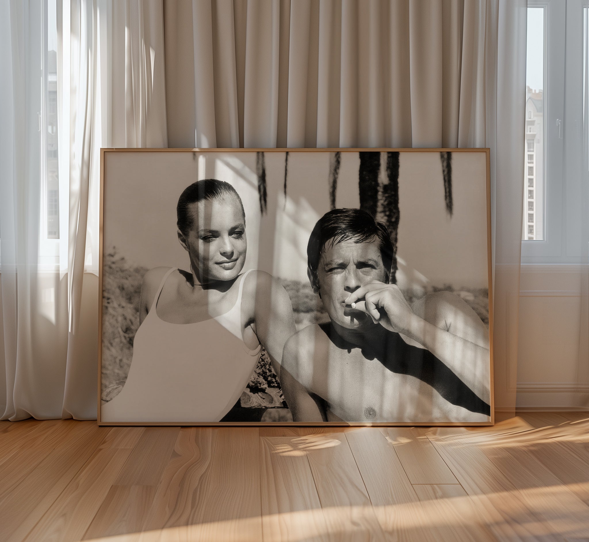 Large framed photograph of Romy Schneider and Alain Delon displayed in a sunlit contemporary interior