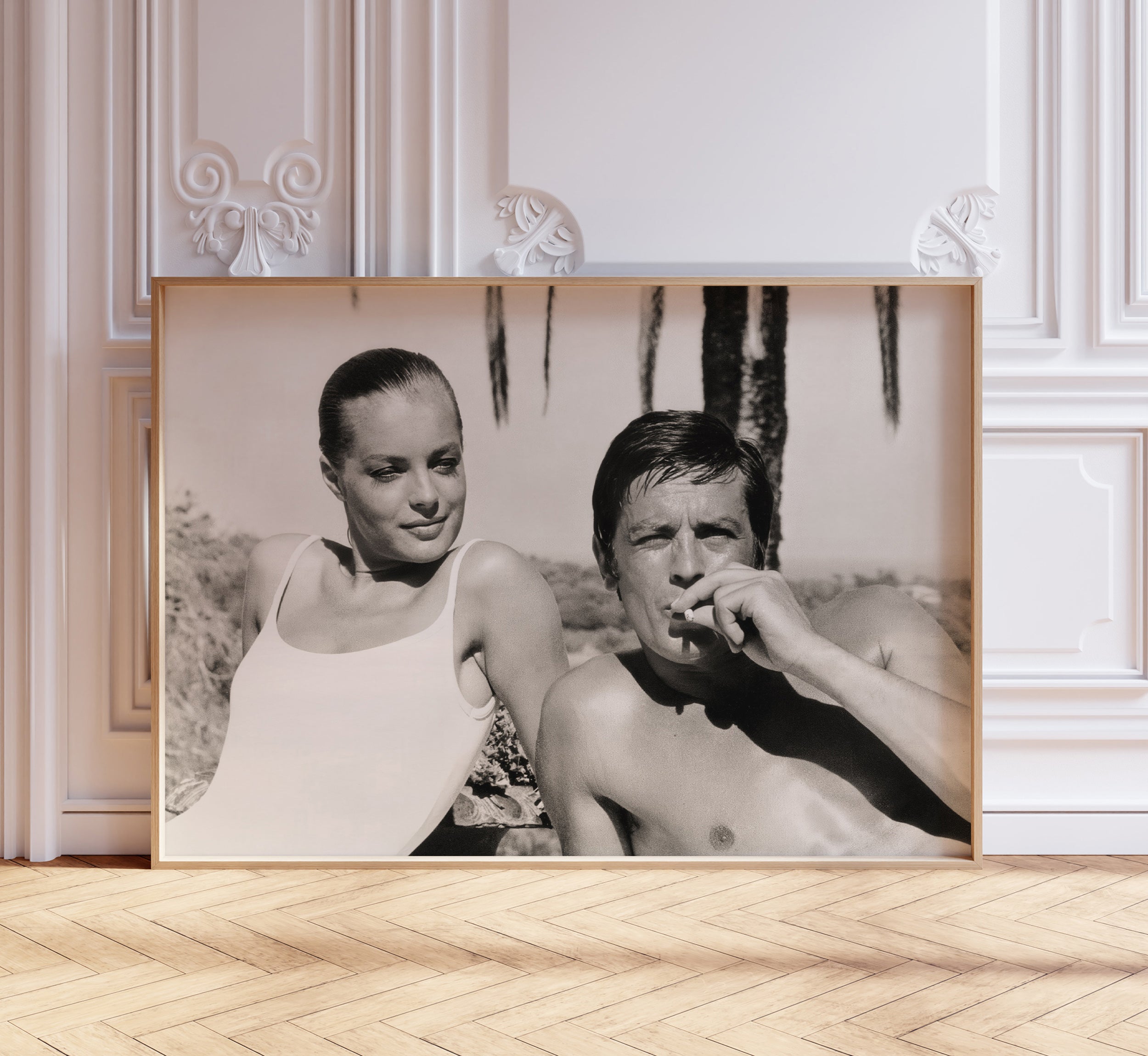 Black and white photograph of Romy Schneider and Alain Delon displayed as large framed wall art in an elegant interior